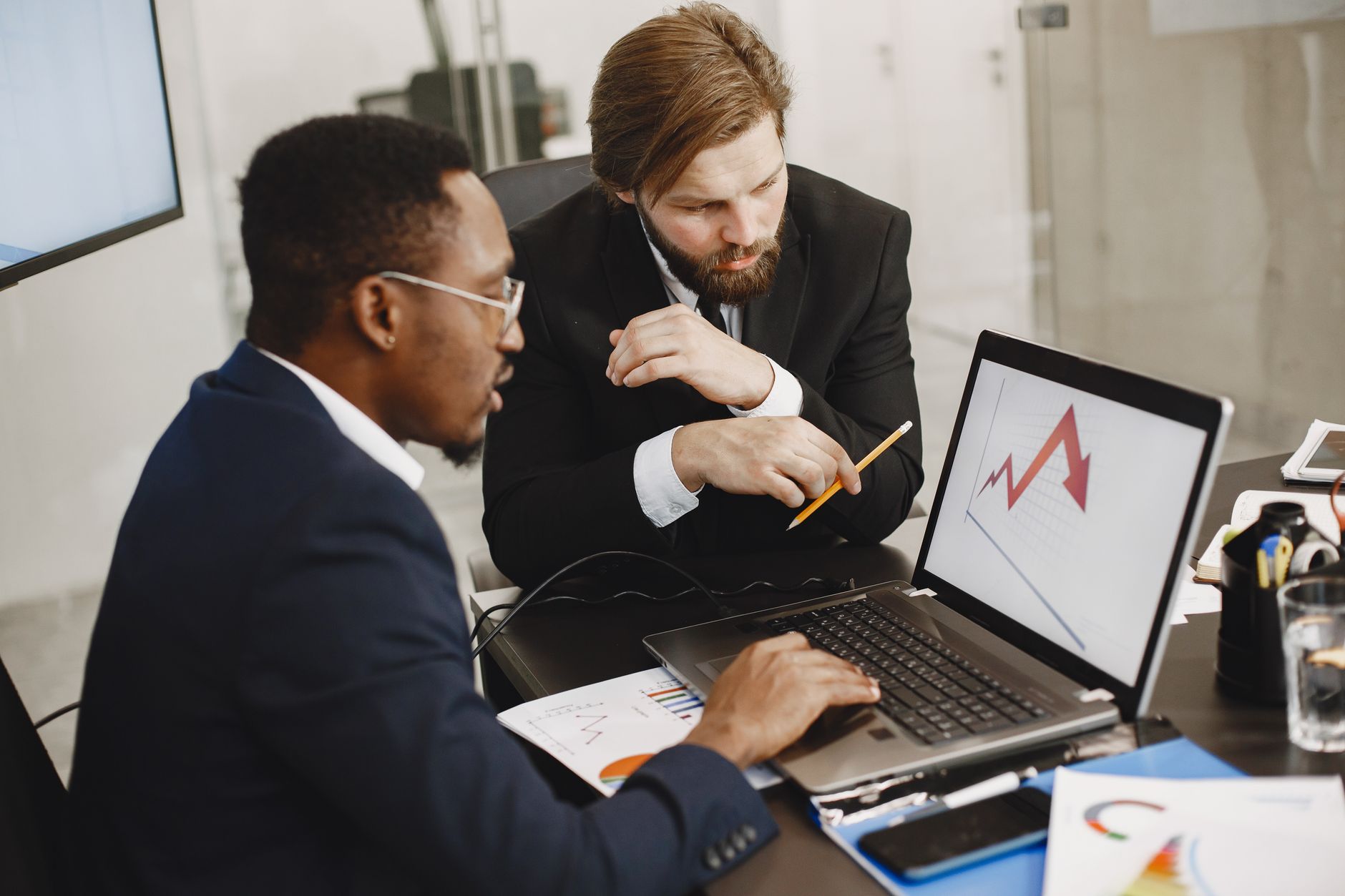 Two business professionals discuss marketing data on a laptop in a modern office. — 2 Primary Tips To Decide where to buy gel