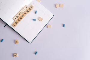 Flat lay of health insurance concept with planner and pills. — Ambiguous Status of Cannabis in Medical Applications