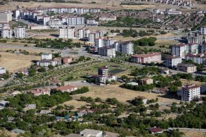Aerial cityscape of Elâzığ, Türkiye showcasing apartments and greenery in summer. — Dermal fillers - What are the benefits?