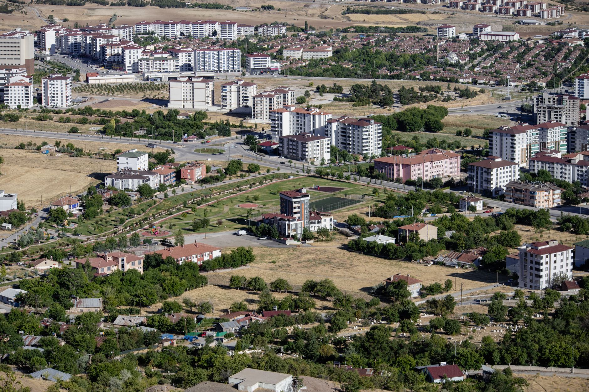 Aerial cityscape of Elâzığ, Türkiye showcasing apartments and greenery in summer. — Dermal fillers - What are the benefits?