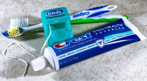 Close-up of dental care items including toothbrush, floss, and toothpaste for oral hygiene. — Elevated Elixirs: Indulge in th