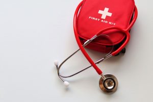 A red first aid kit paired with a stethoscope, signifying healthcare and medical treatment essentials. — Herbalife Nutrition