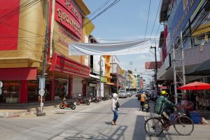 Lively urban street in Thailand with people, shops, and traffic under a sunny sky. — How Tantric Massage Outcall in London Bo