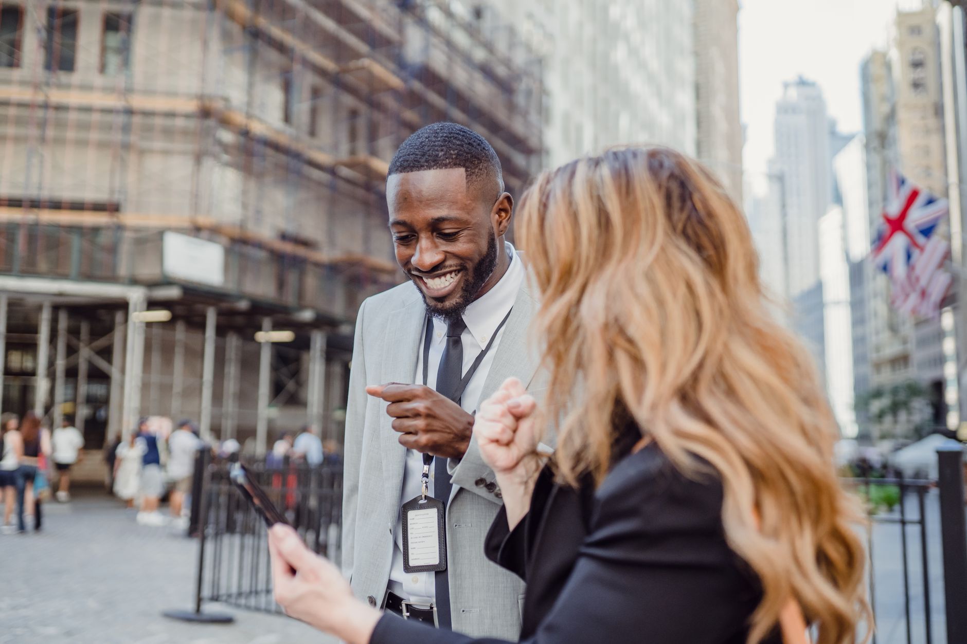 Two business professionals engage in lively conversation on an urban street, sharing insights. — How to clean your washing ma