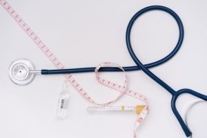 A stethoscope, ampoule, and tape measure on a white background symbolize healthcare essentials. — How to Find the Best Medica