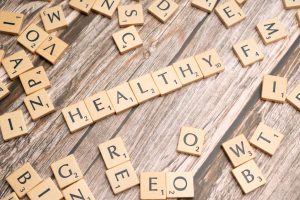 Wooden letter tiles arranged on a wooden surface spelling out 'healthy', symbolizing wellness. — Important Considerations Bef