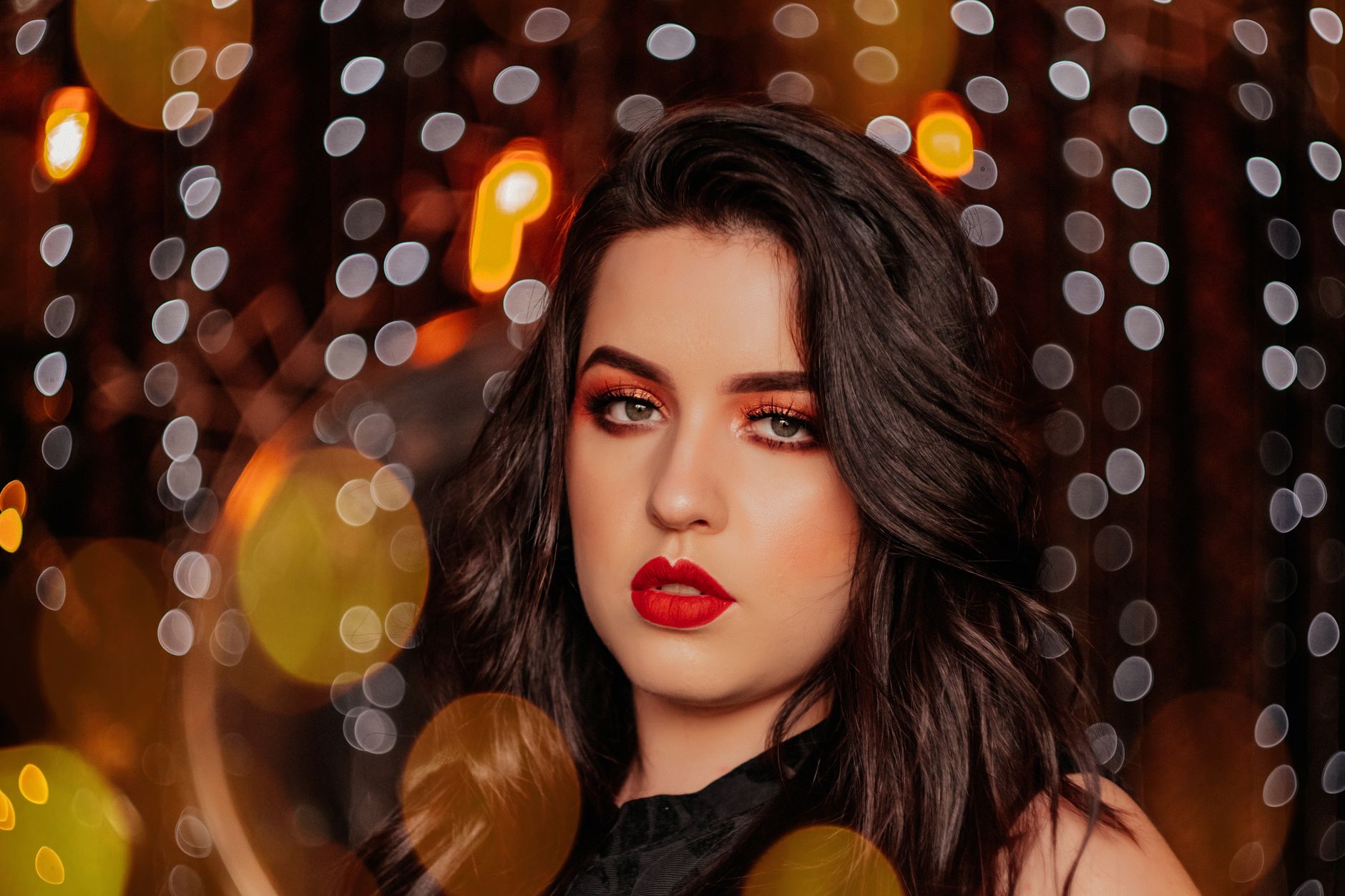 Elegant close-up of a woman with bold makeup in a bokeh lights setting. — Long Eyelashes Contribute to the Health of Your Eye