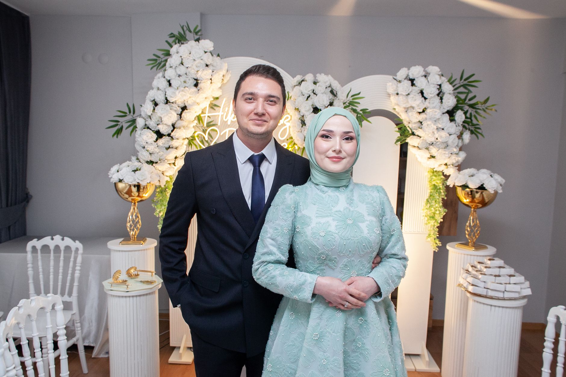A newlywed couple posing elegantly at their wedding with floral decor indoors. — Myths about CBD Oil