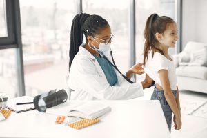 A female doctor gives a health check-up to a child in a bright clinic. — Promote Your Overall Health With The Help Of Green T