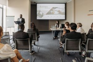 A diverse group of adults attending a presentation in a conference room setting. — Revive Collagen: Unlocking the Sec