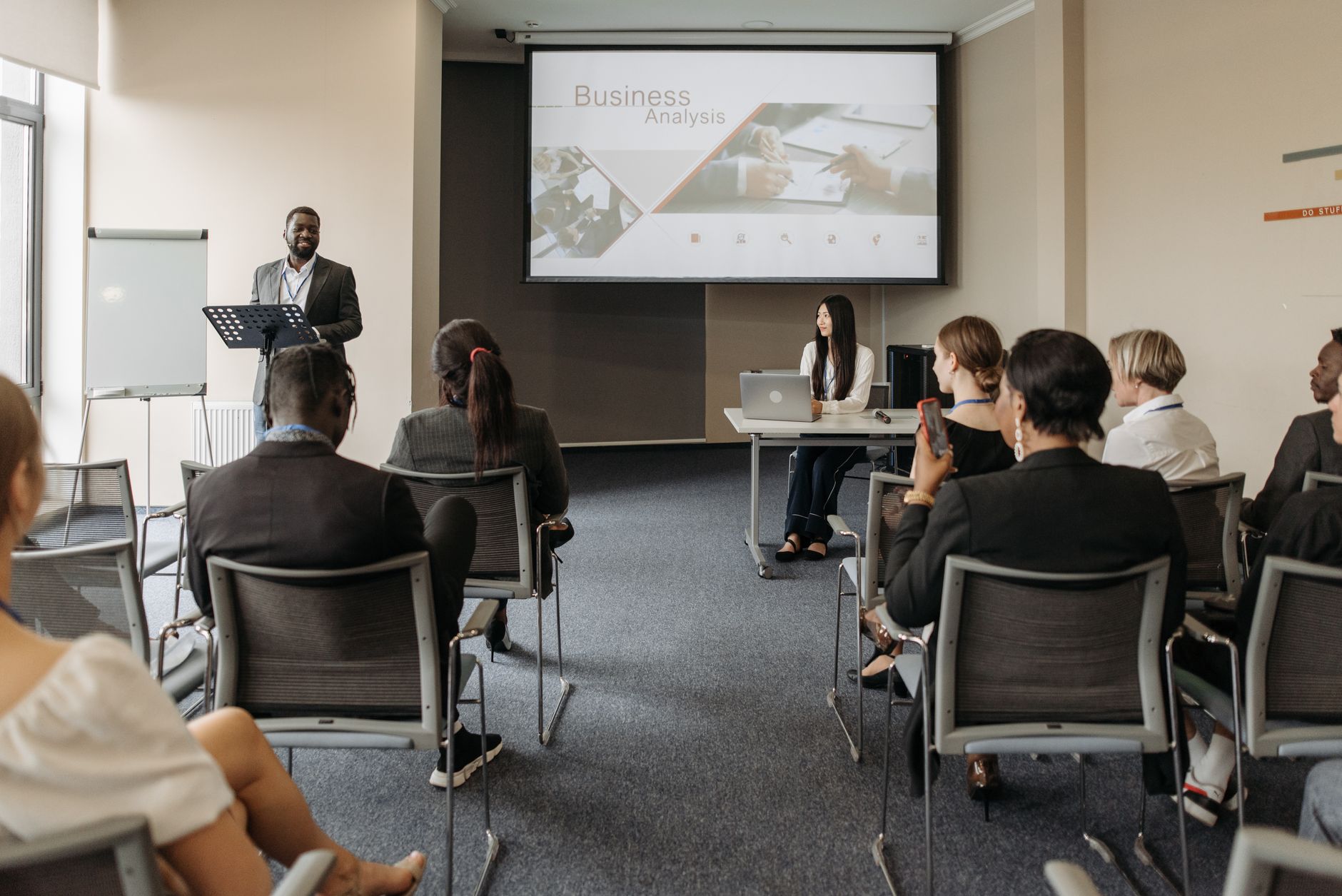 A diverse group of adults attending a presentation in a conference room setting. — Revive Collagen: Unlocking the Sec