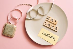 A conceptual image featuring a plate with messages made from Scrabble tiles and a tape measure, promoting healthy eating. — S