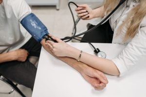 A doctor measures a patient's blood pressure with a sphygmomanometer during a consultation. — The Advantages and Disadvantage