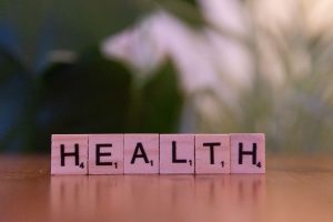 Close-up of Scrabble tiles spelling 'Health' on a wooden table with a blurred background. — The Convenience of Buying Testost
