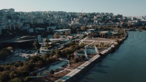 Aerial panoramic view of Istanbul's urban skyline and waterfront along the Golden Horn, showcasing architecture and natural b