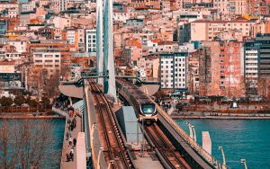 Metro train crossing a bridge in Istanbul with a vibrant cityscape backdrop. — The Impact of Med Spa Practitioners on Wellnes
