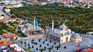 Vibrant aerial view of the iconic Mevlana Museum located in Konya, Türkiye, surrounded by lush greenery. — The Ultimate Playl