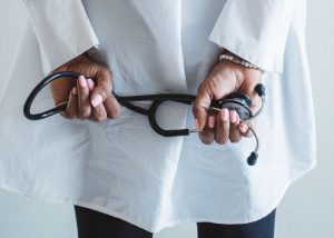 A medical professional holding a stethoscope in a clinical setting. — Titanium Usage In Medical Procedures
