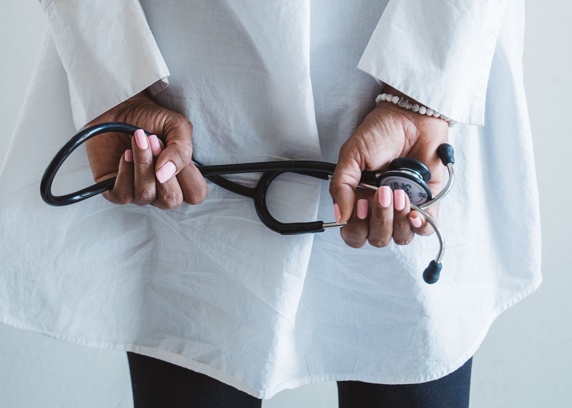 A medical professional holding a stethoscope in a clinical setting. — Titanium Usage In Medical Procedures