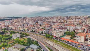 Aerial view of dense urban architecture with roads and greenery under cloudy skies. — Understanding the Role of an Ophthalmol