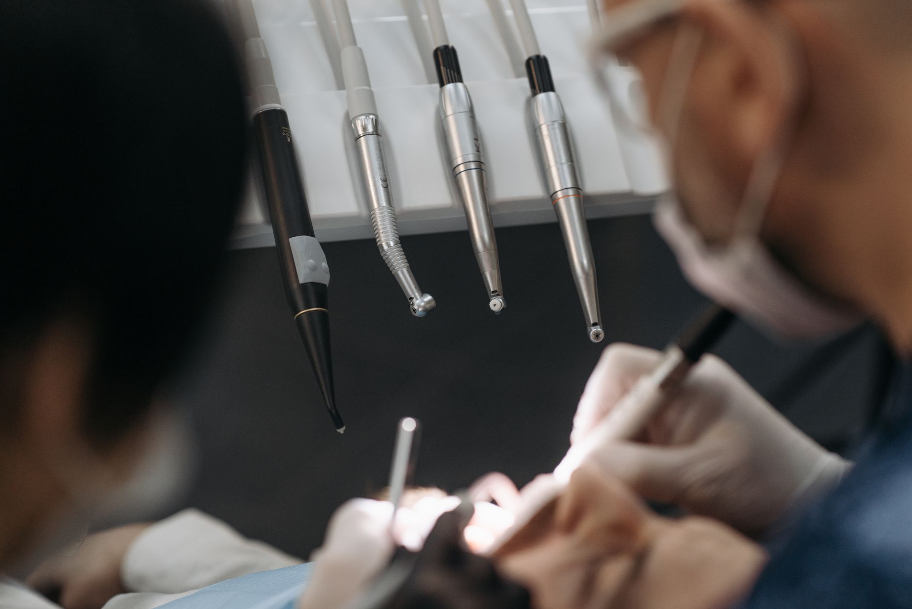 Close-up of dentists working on a patient with specialized dental instruments. — What Does Expert Cosmetic Dentistry in Powel