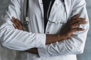 Close-up of a confident doctor in a lab coat standing with crossed arms and stethoscope. — What Products Do You Need for Lash