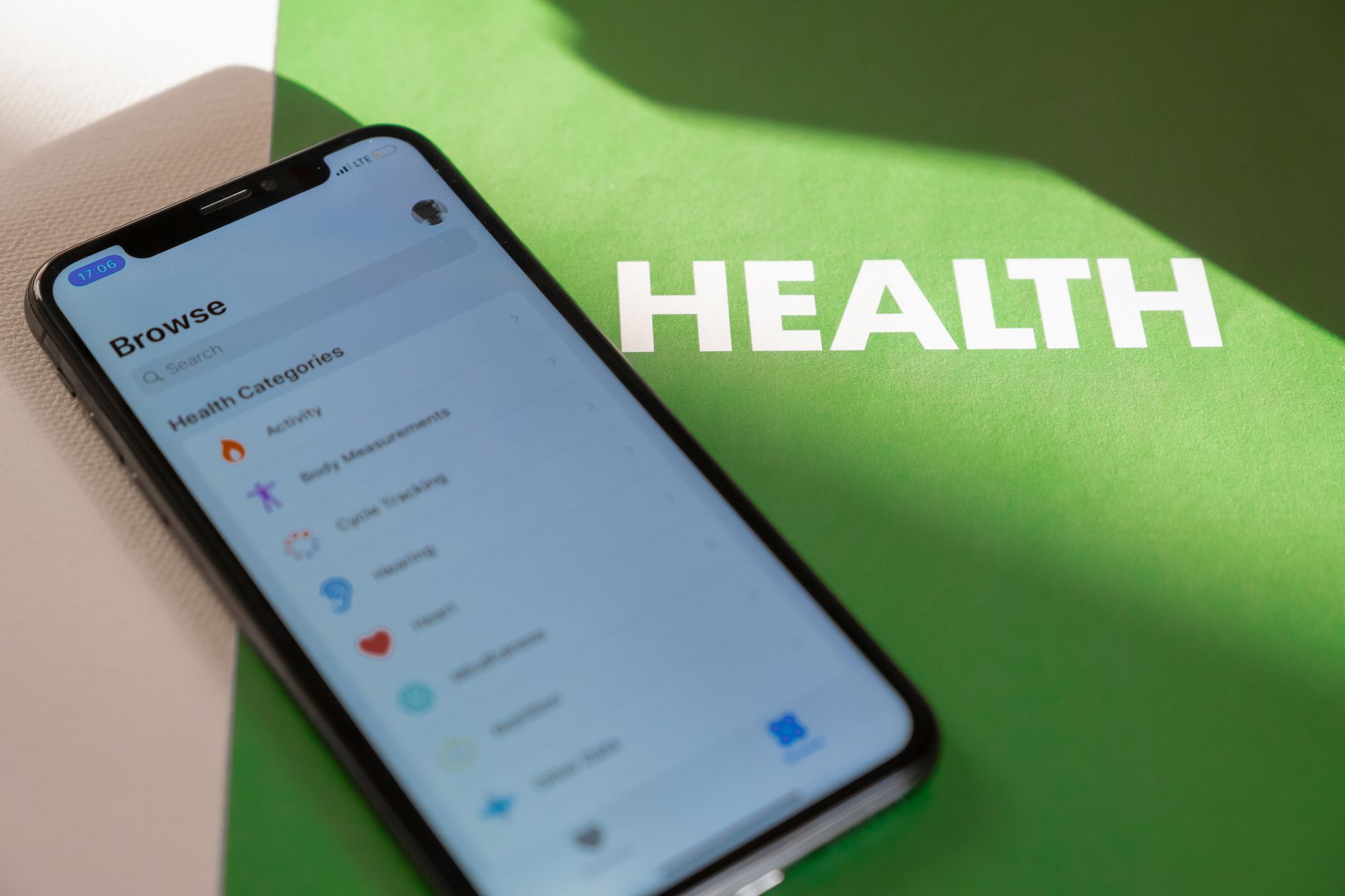 Close-up of a smartphone displaying a health app on a green surface with 'HEALTH' text. — What to Look for When Choosing Alco