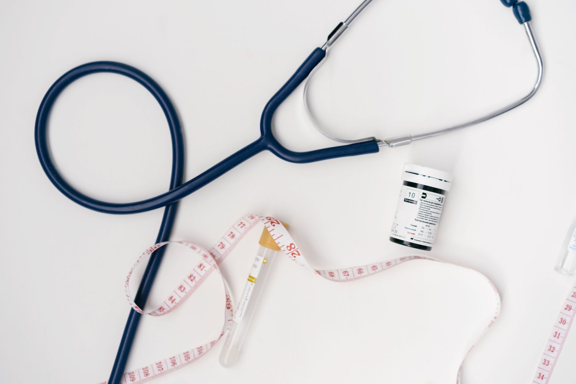 Flat lay of medical tools including stethoscope and measuring tape on a white background. — Why OC Addiction Treatment Center