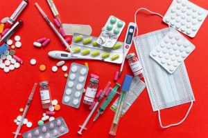 Medical supplies and medications displayed on a red background, emphasizing healthcare essentials. — YOUR GUIDE TO TEETH WHIT